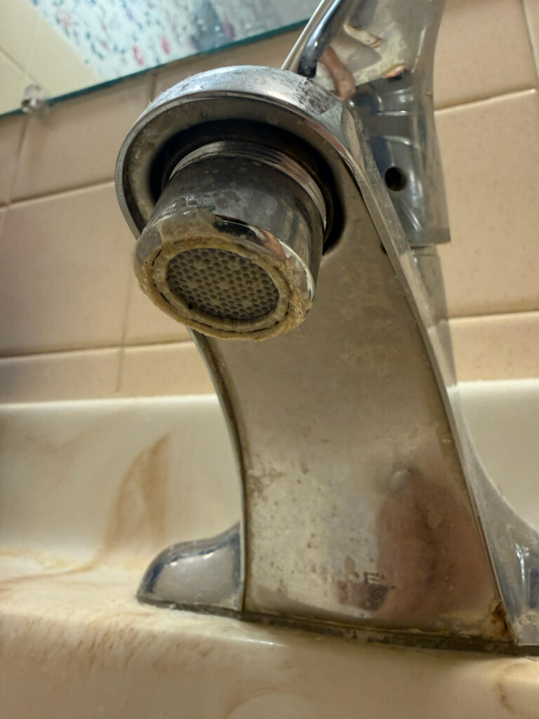 Signs of hard water in Northern Illinois shown by mineral buildup on a faucet aerator